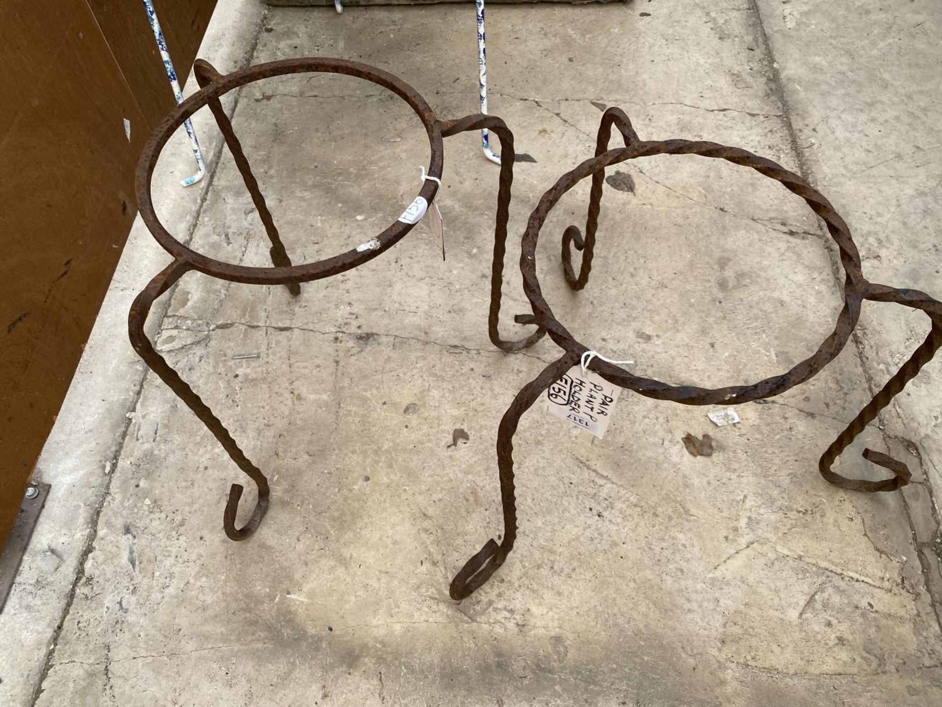 TWO WROUGHT IRON TRIPOD PLANT POT HOLDERS