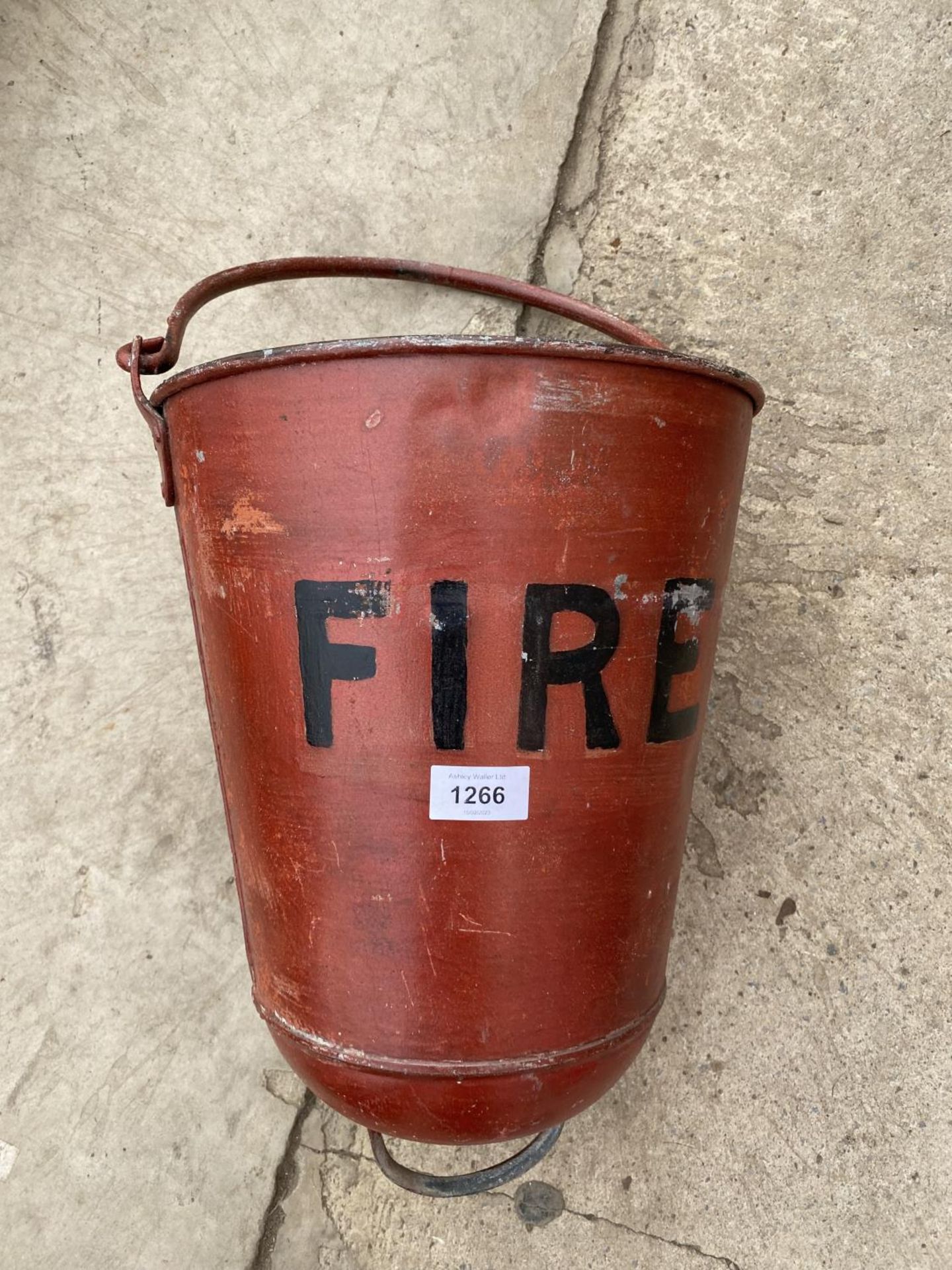 AN UNUSUAL CURVED BOTTOMED FIRE BUCKET