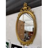 A DECORATIVE GILT FRAMED WALL MIRROR