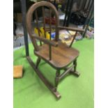 A VINTAGE CHILDS ROCKING CHAIR