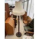 AN ORIENTAL HARDWOOD STANDARD LAMP COMPLETE WITH SHADE