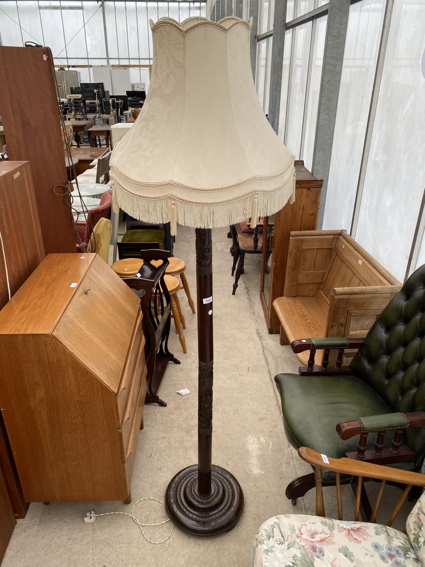 AN ORIENTAL HARDWOOD STANDARD LAMP COMPLETE WITH SHADE