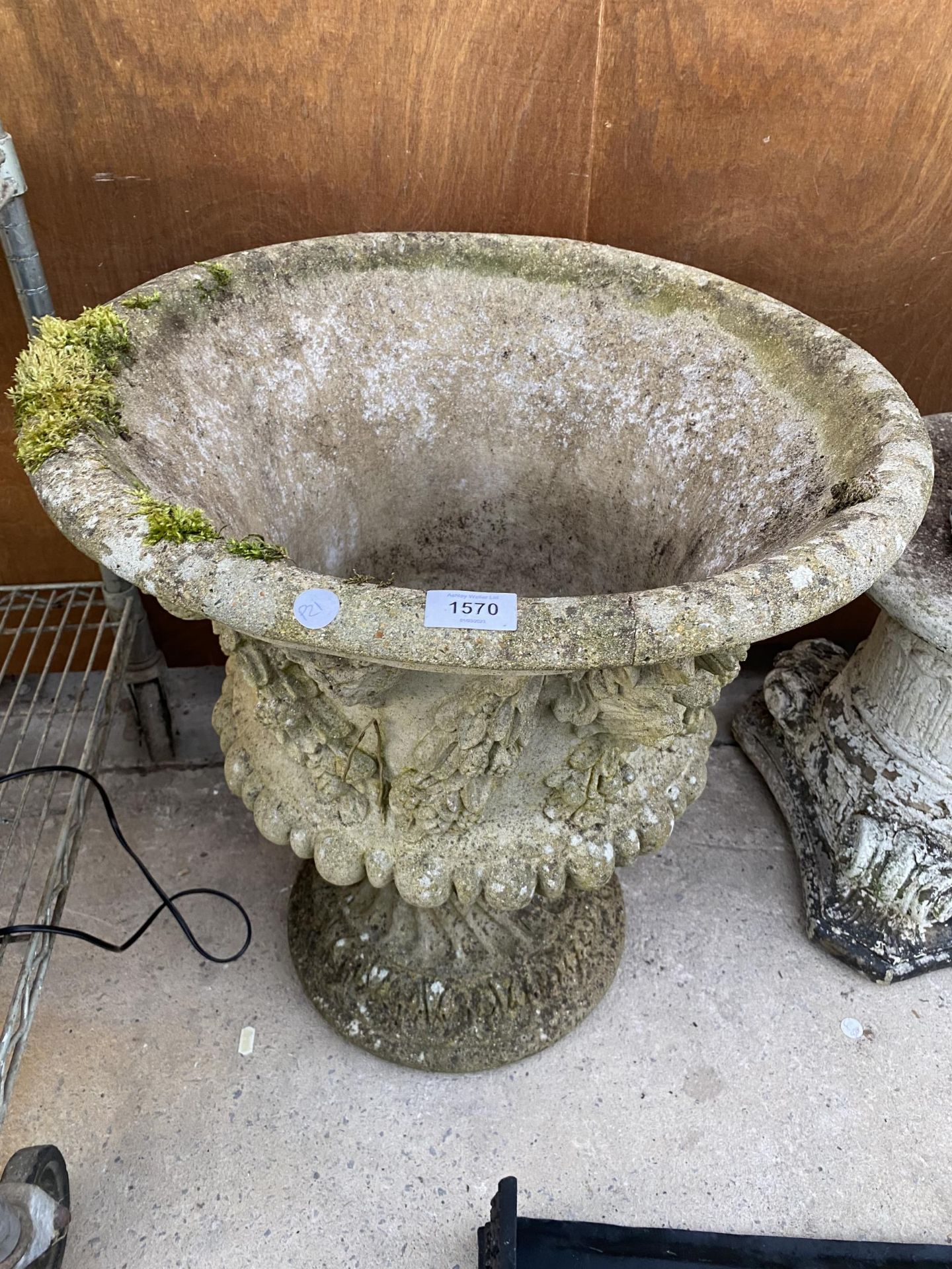 A LARGE RECONSTITUTED STONE URN PLANTER