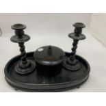 AN EBONY DRESSING TABLE SET TO INCLUDE A TRAY, CANDLESTICKS AND A TRINKET BOWL