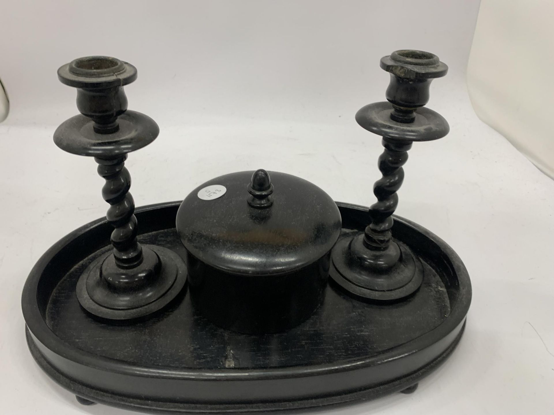 AN EBONY DRESSING TABLE SET TO INCLUDE A TRAY, CANDLESTICKS AND A TRINKET BOWL