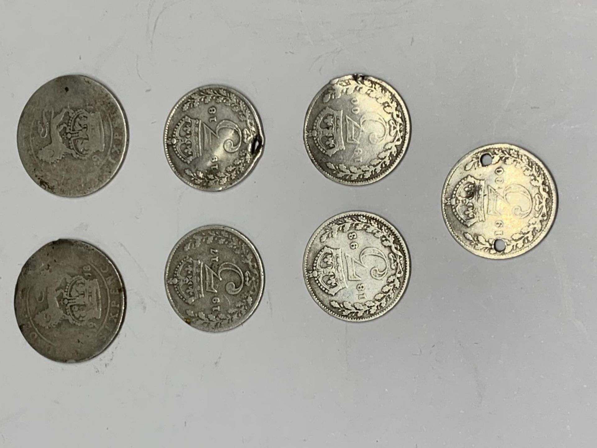 SEVEN SILVER COINS TO INCLUDE THREE PENCES AND SIX PENCES