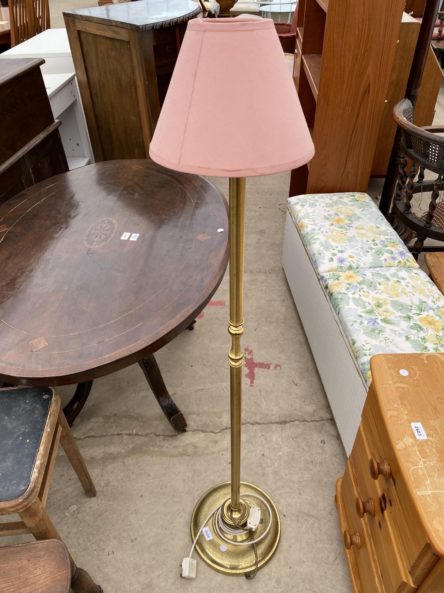 A SMALL BRASS STANDARD LAMP COMPLETE WITH SHADE