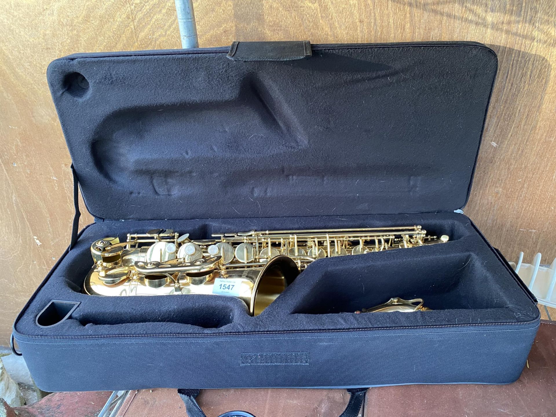 A BRASS CASED AMMOON SAXAPHONE