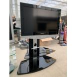 A SAMSUNG 32" TELEVISIOV ON GLASS DISPLAY STAND