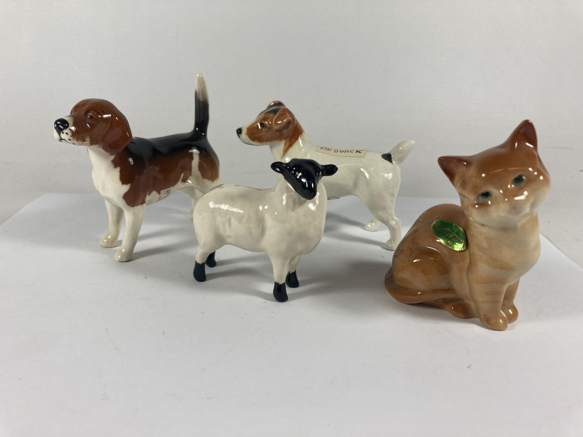 FOUR BESWICK FIGURES TO INCLUDE A JACK RUSSEL, HOUND, A LAMB AND A CAT