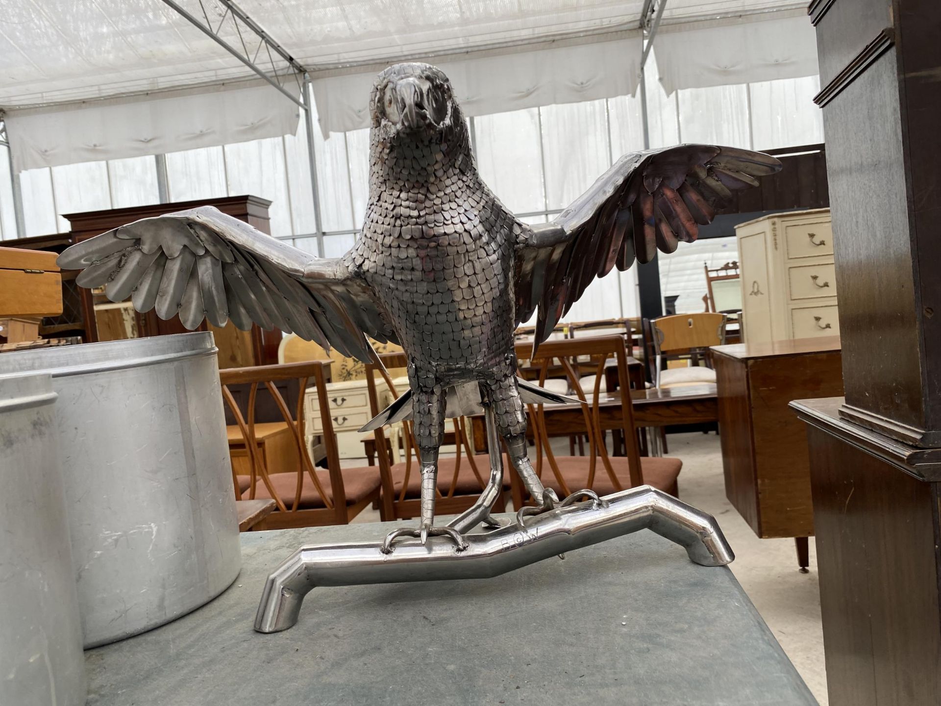 A STAINLESS STEEL EAGLE WITH WINGS SPANNED OUT
