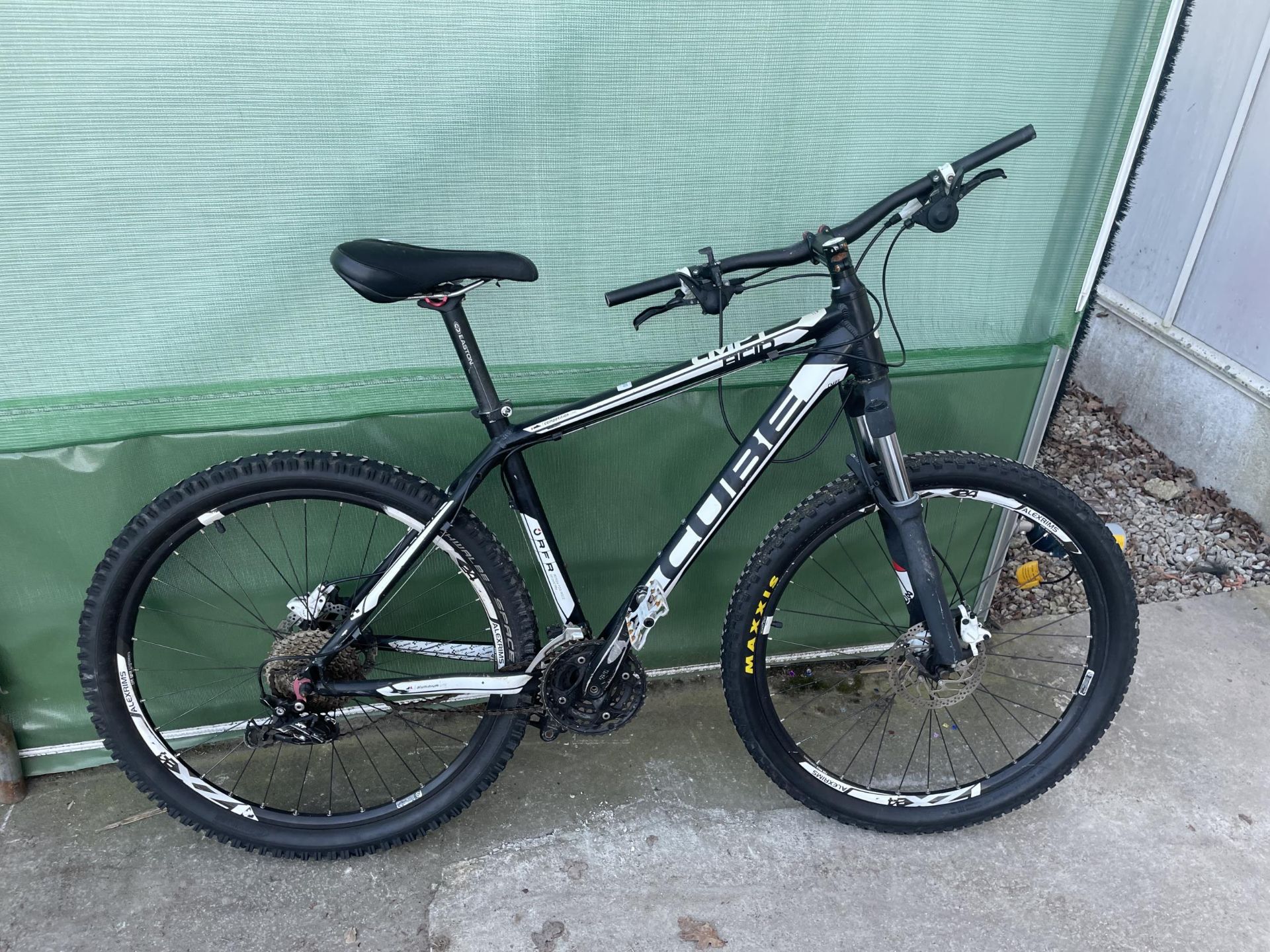 A CMPT CUBE MOUNTAIN BIKE WITH FRONT SUSPENSION AND 30 SPEED GEAR SYSTEM