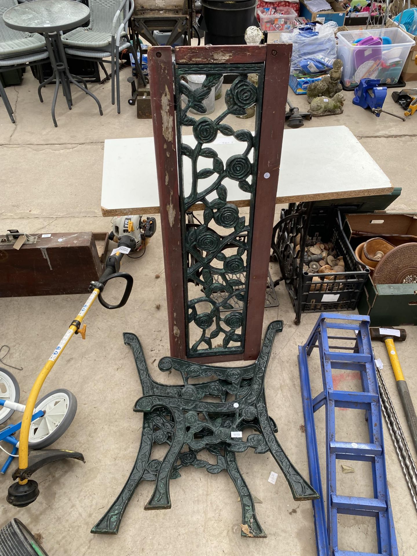 A PAIR OF DECORATIVE CAST IRON BENCH ENDS AND A FLORAL CAST IRON BENCH BACK