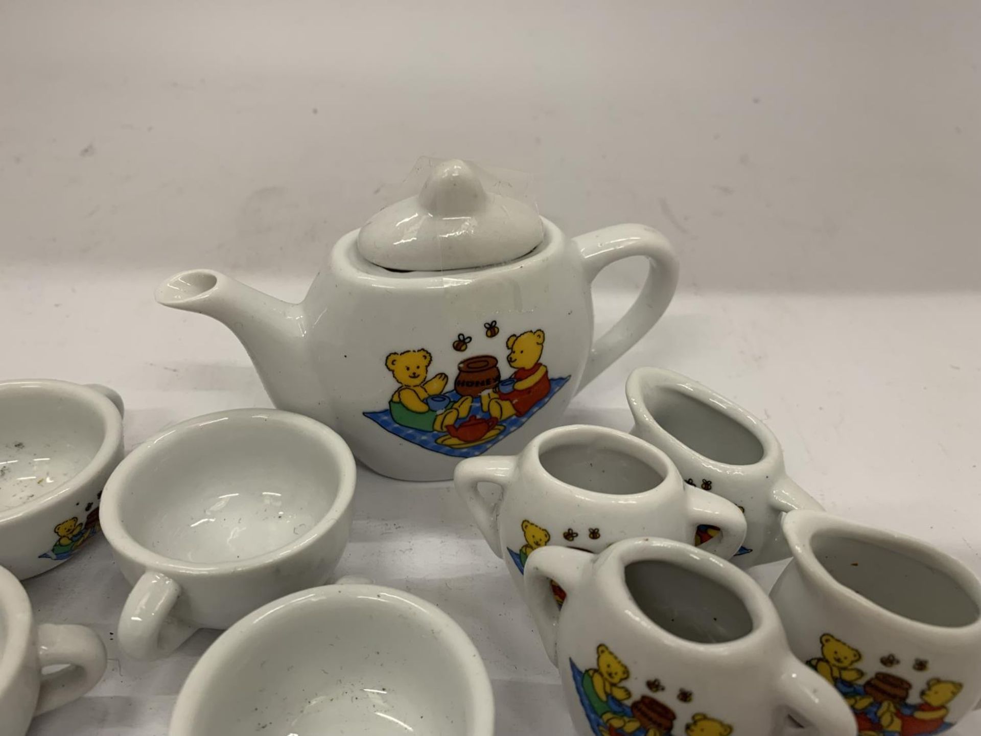 A MINIATURE CHILD'S POTTERY TEASET TO INCLUDE TEAPOT, JUGS, CUPS, ETC WITH A TEDDY BEARS PICNIC - Image 6 of 10