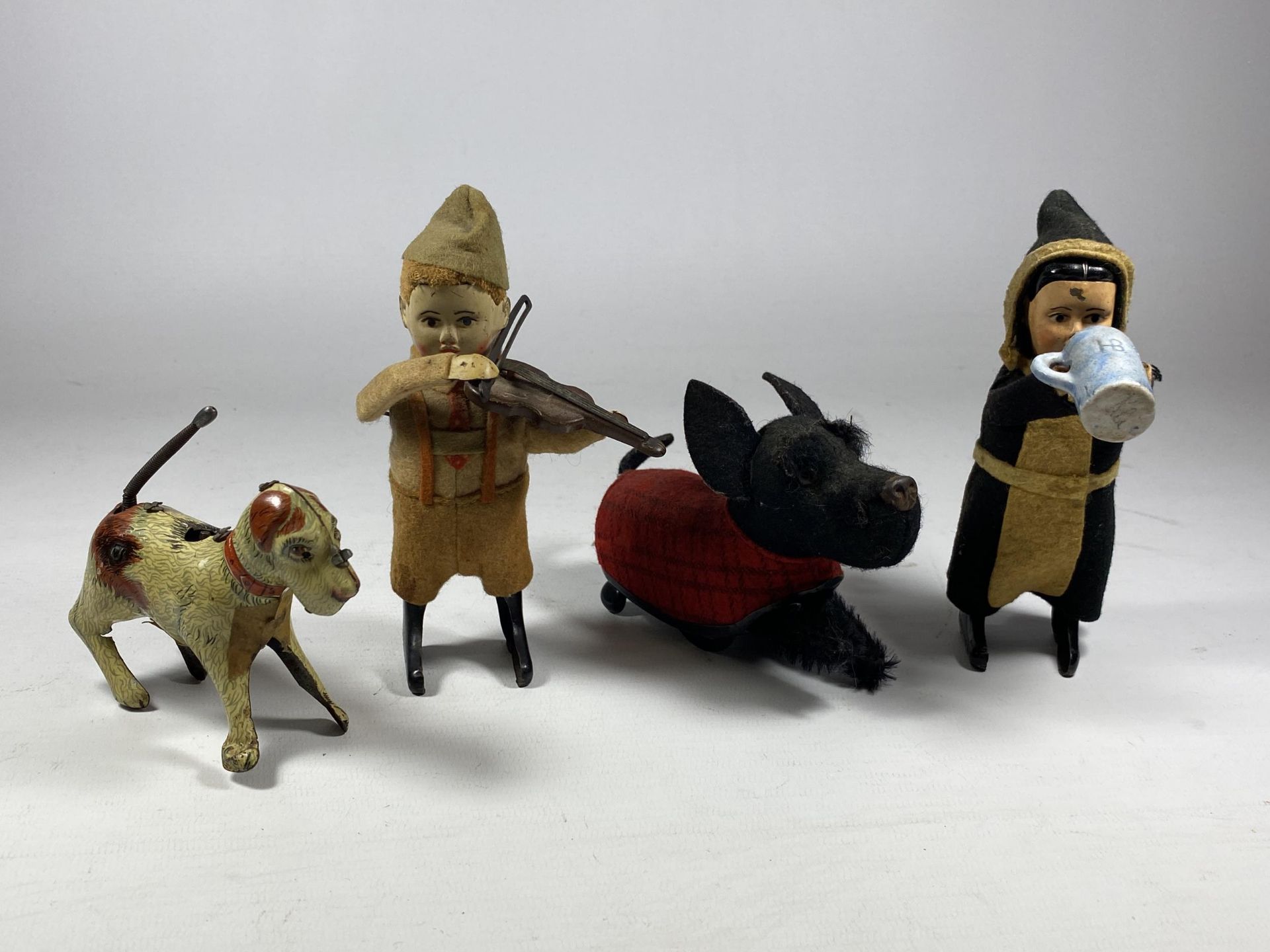 FOUR VINTAGE WIND UP FIGURES TO INCLUDE THREE SCHUCO - THE DRINKING MONK, THE DUTCHMAN WITH THE