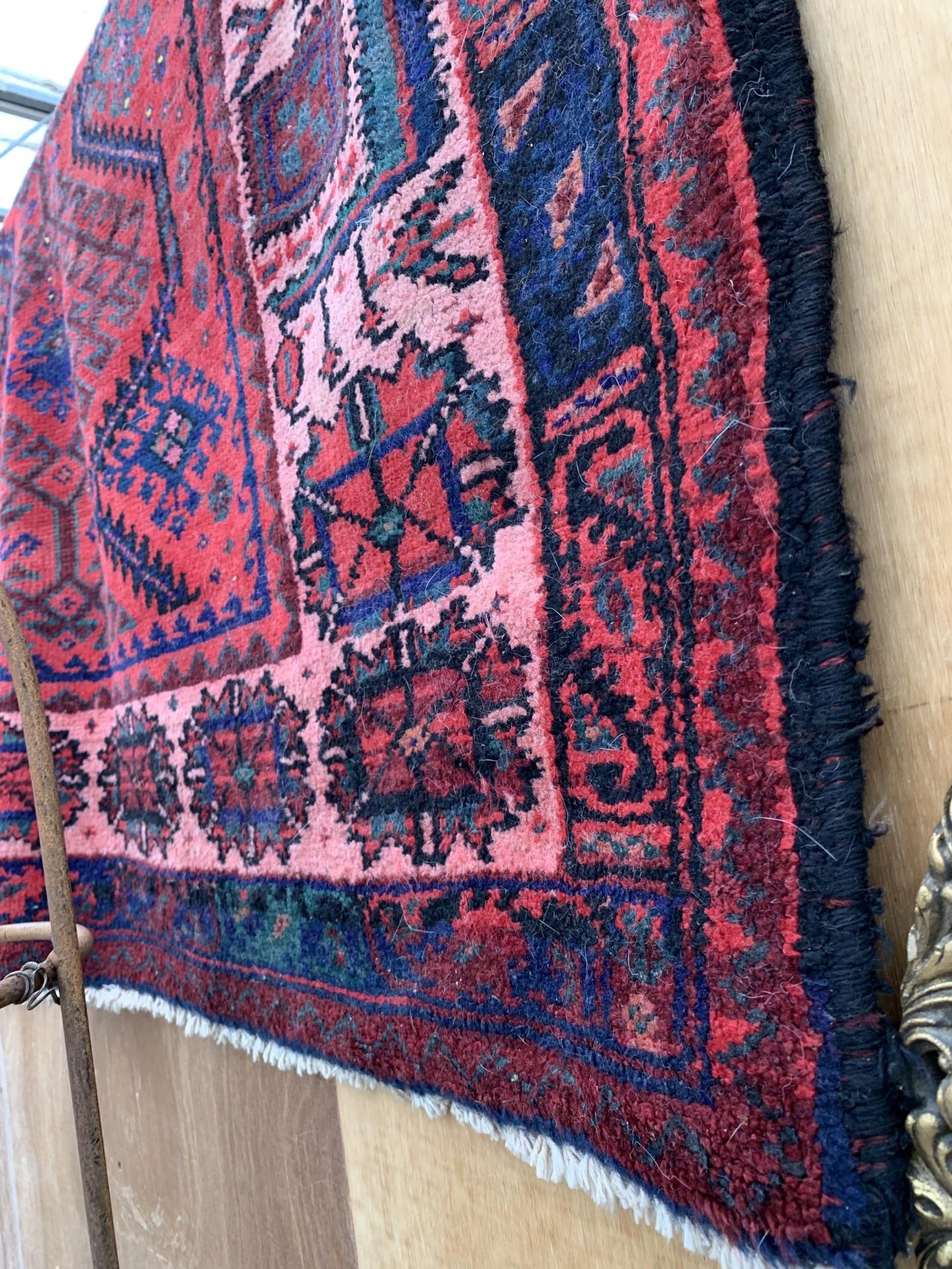 A RED PATTERNED FRINGED RUG - Image 2 of 2