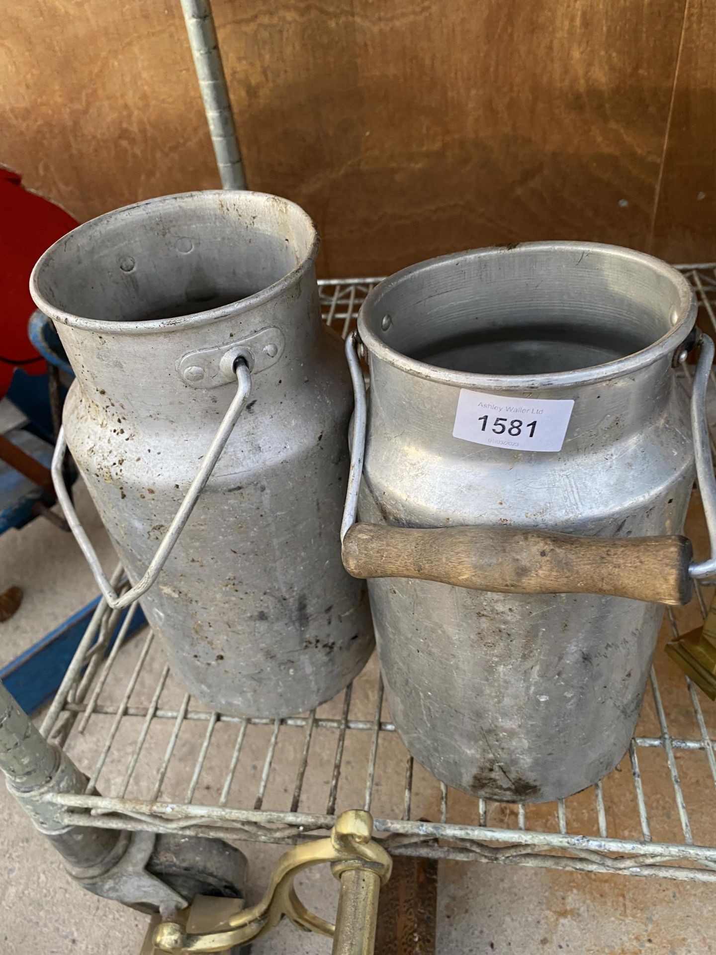 A PAIR OF METAL MILK CANS (LACKING LIDS)