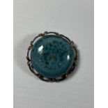 A RUSKIN POTTERY AND HALLMARKED SILVER MOUNTED BROOCH