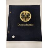 A VINTAGE GERMAN STAMP ALBUM TO INCLUDE STAMPS FROM THE 1870'S ONWARDS