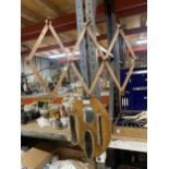 A VINTAGE FOLDING COAT/HAT RACK AND A MIRROR WITH THREE BRUSHES