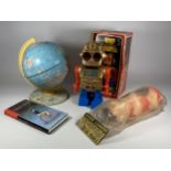 FOUR ITEMS - A BOXED ELECTRONIC SPACE MONSTER, PLASTIC FRED FLINTSTONE MONEY BANK, BOOK & TIN GLOBE