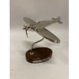 A MODEL OF A CHROME SPITFIRE ON A WOODEN BASE HEIGHT 19CM