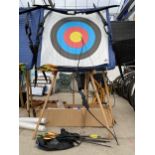 AN ASSORTMENT OF ARCHERY EQUIPMENT TO INCLUDE A TARGET BOARD, THREE BOWS, A NUMBER OF ARROWS AND