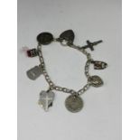 A SILVER BRACELET WITH EIGHT CHARMS