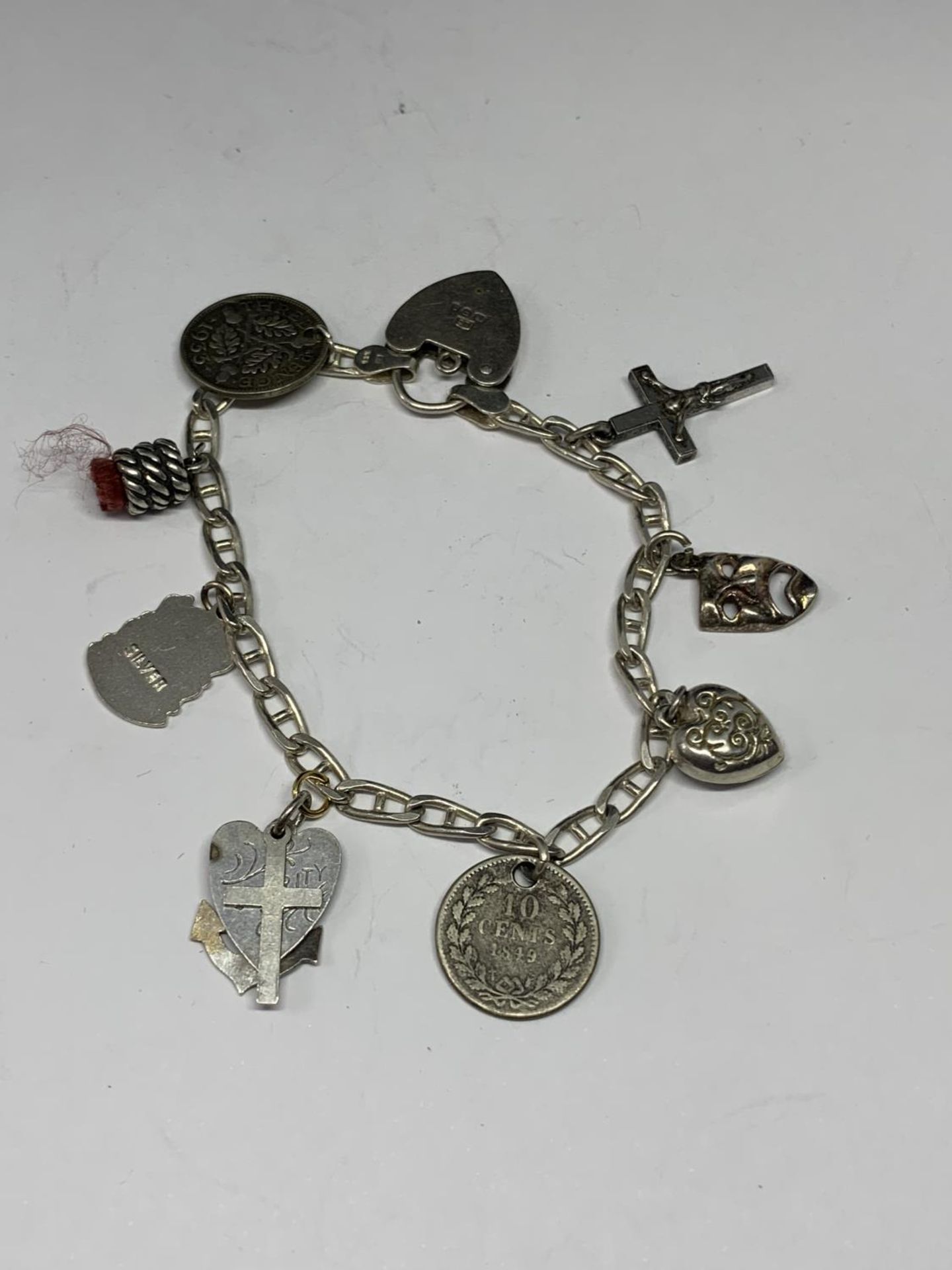 A SILVER BRACELET WITH EIGHT CHARMS