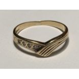 A 9 CARAT GOLD WISHBONE RING WITH FOUR DIAMONDS SIZE M