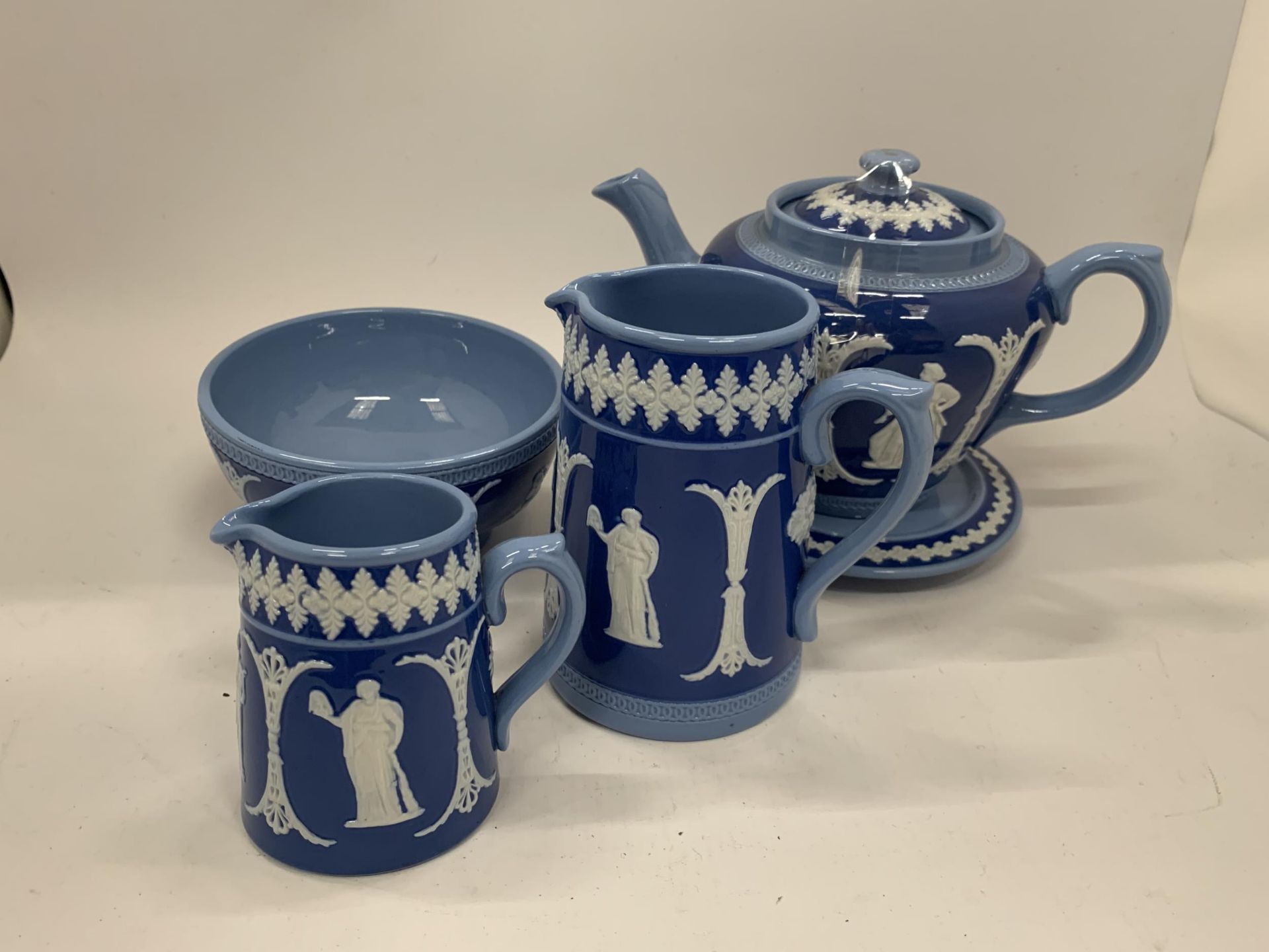 FOUR PIECES OF DUDSON POTTERY IN A JASPERWARE STYLE PATTERN TO INCLUDE A TEAPOT AND STAND, JUGS