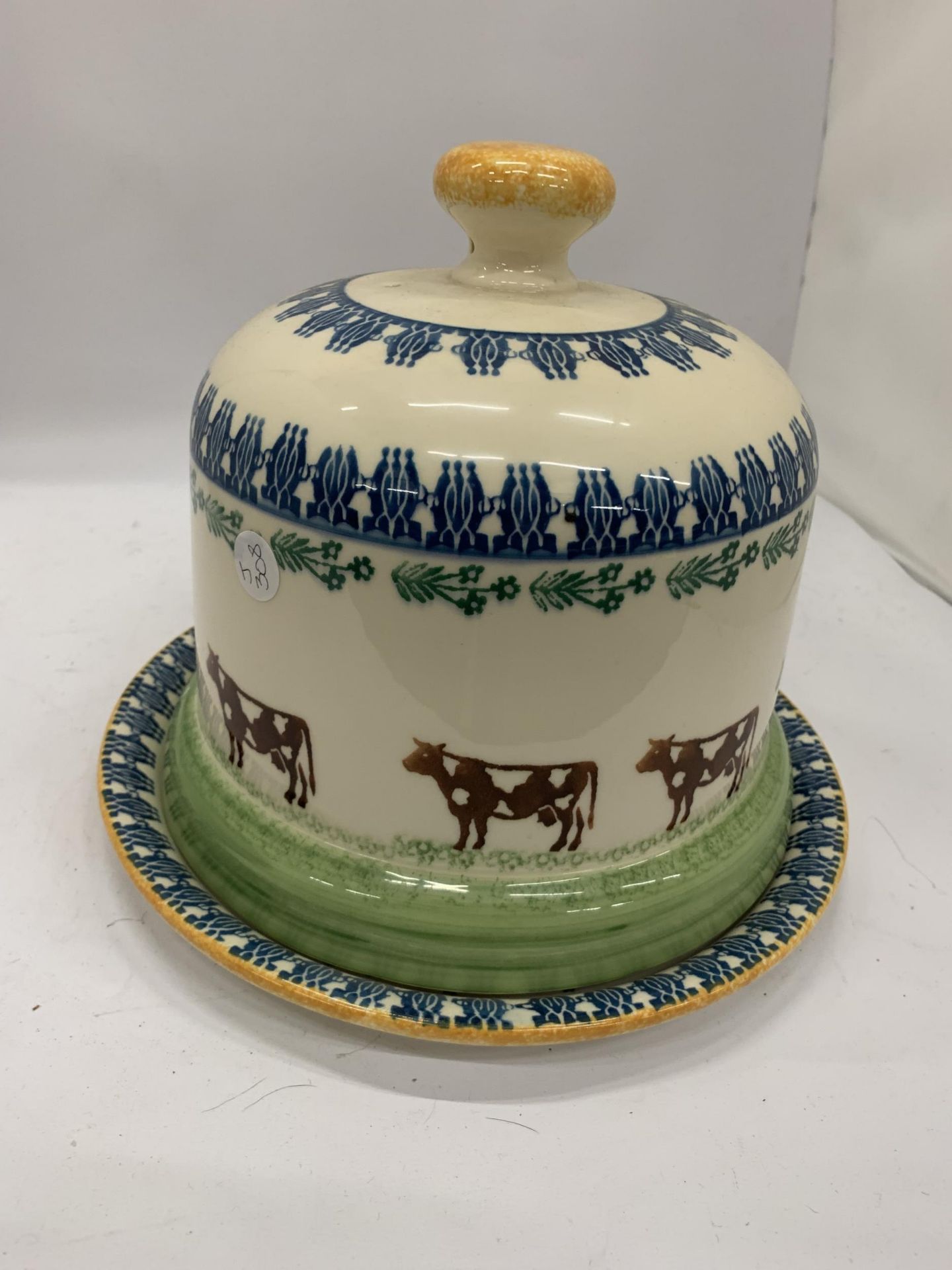 A LARGE MOORLAND POTTERY CHEESE PLATE AND DOME WITH COW DECORATION
