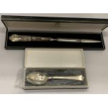 TWO BOXED ITEMS TO INCLUDE A SILVER HANDLED LETTER OPENER & A SILVER TEASPOON