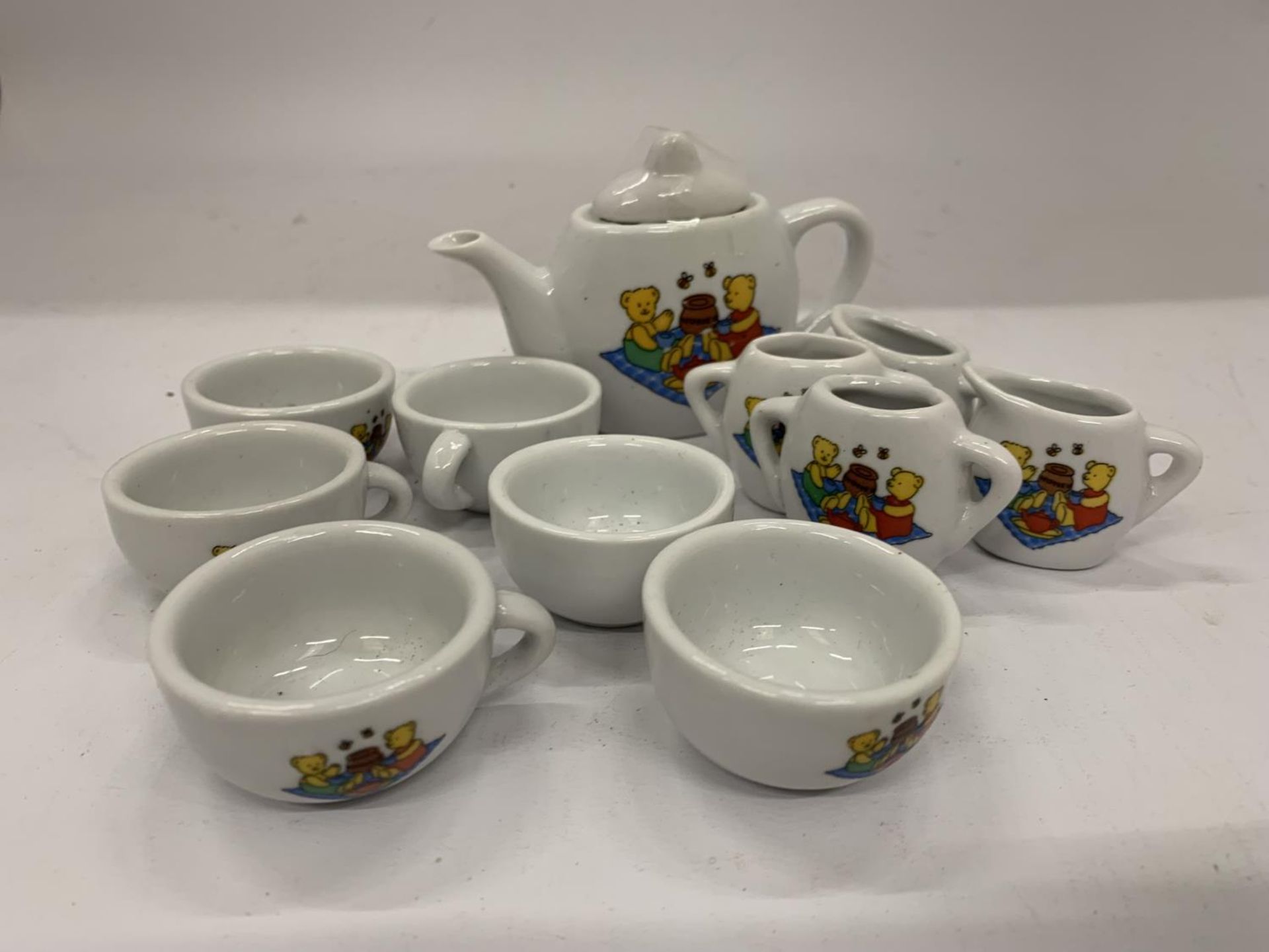 A MINIATURE CHILD'S POTTERY TEASET TO INCLUDE TEAPOT, JUGS, CUPS, ETC WITH A TEDDY BEARS PICNIC - Image 2 of 10