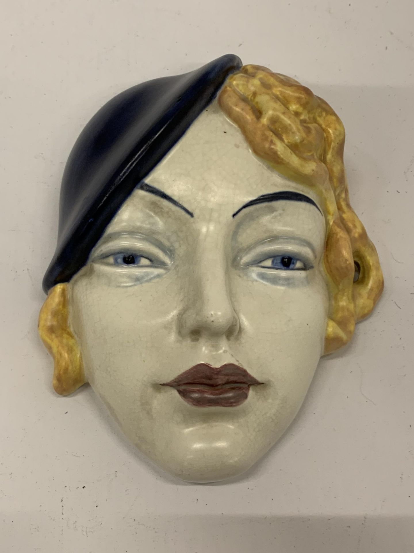 AN ART DECO STYLE FACE MASK, STAMPED 197, MADE IN ENGLAND