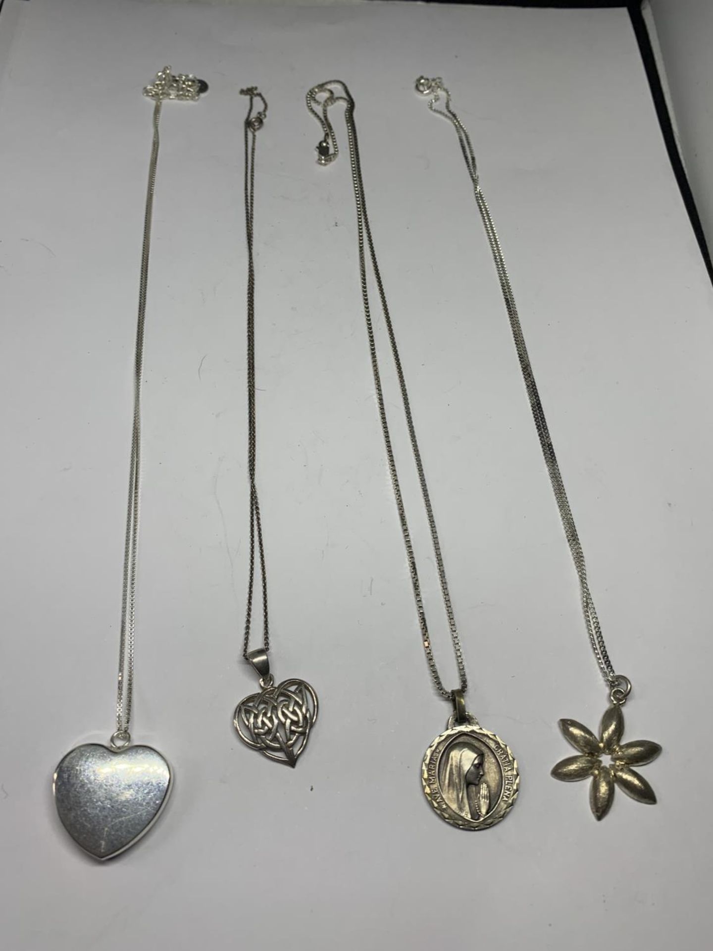 FOUR SILVER NECKLACES WITH PENDANTS