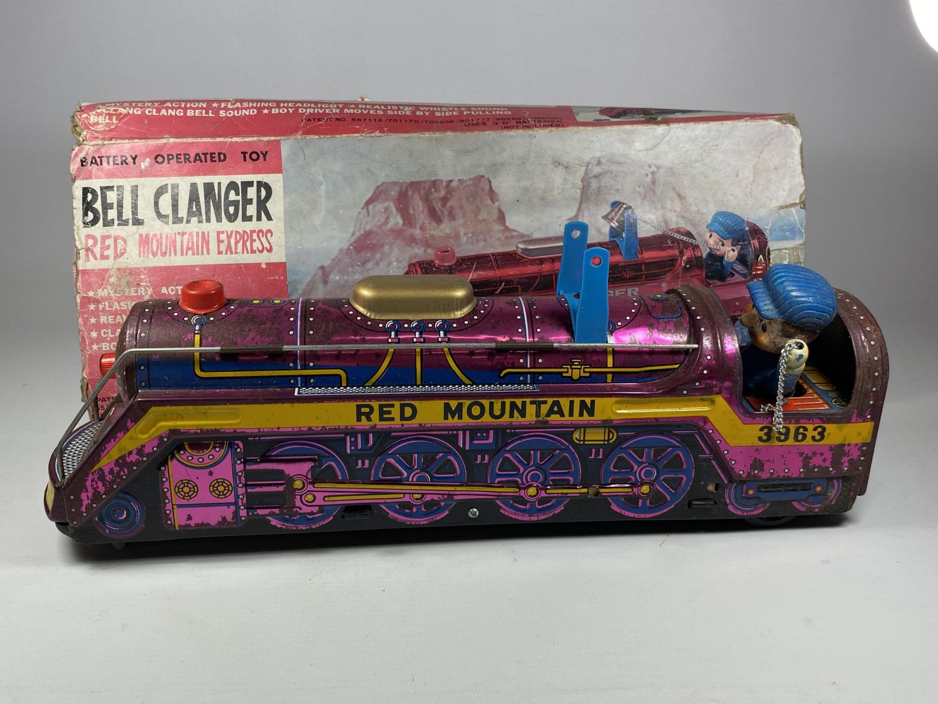 A BOXED BATTERY OPERATED TIN RED MOUNTAIN EXPRESS BELL CLANGER TRAIN