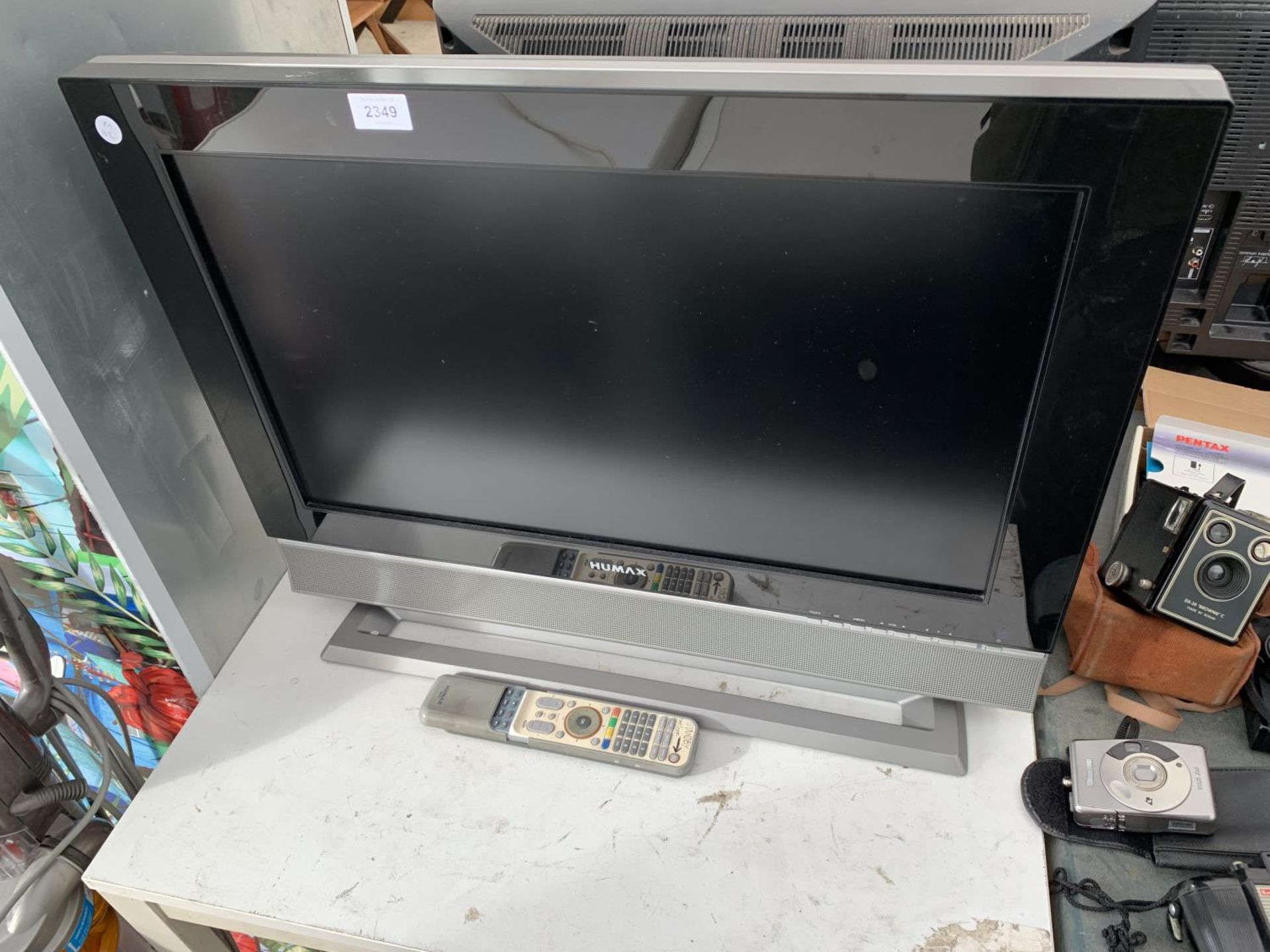 A HUMAX 26" TELEVISION WITH REMOTE CONTROL