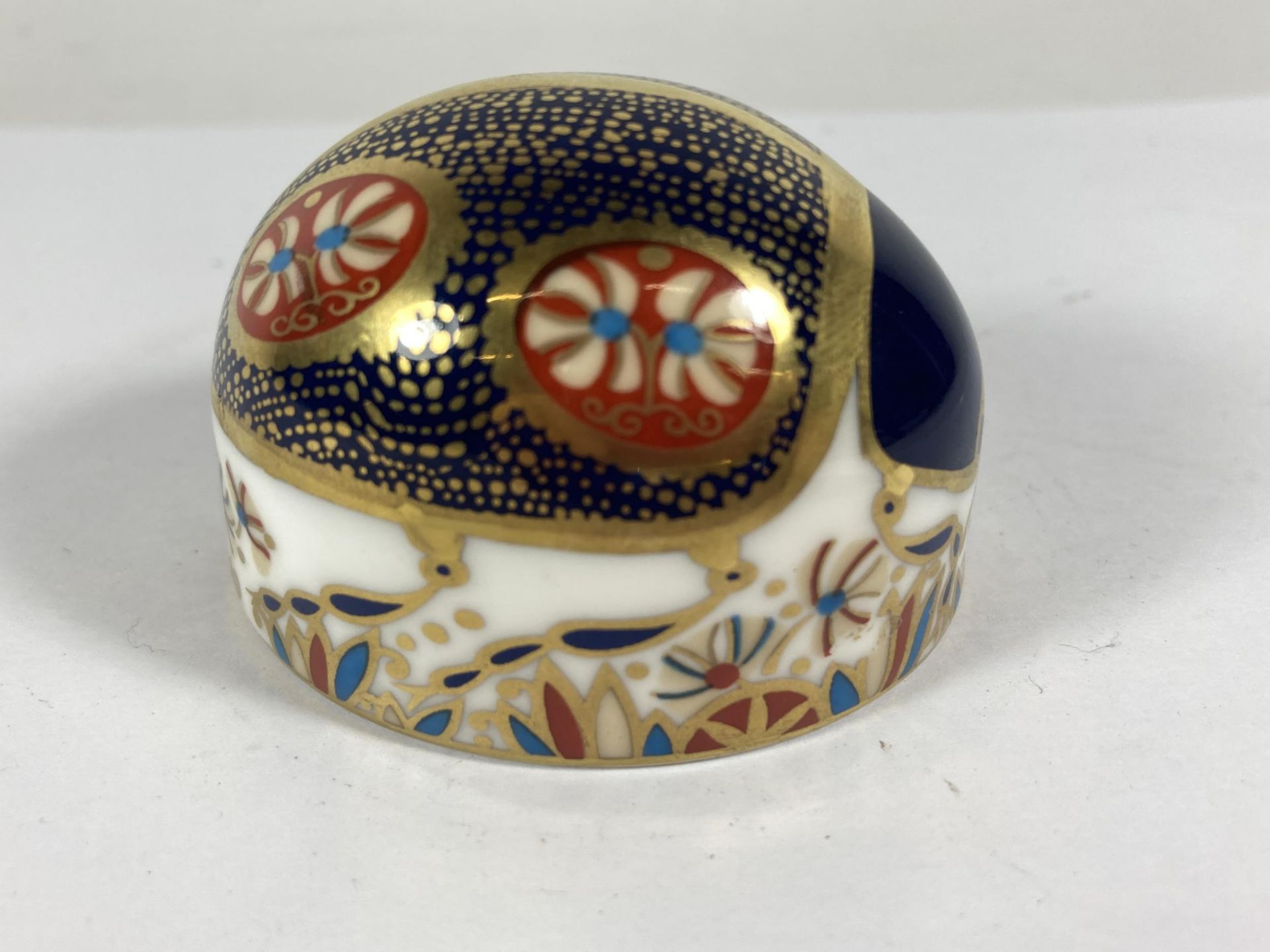 A ROYAL CROWN DERBY BLUE LADYBIRD WITH GOLD STOPPER