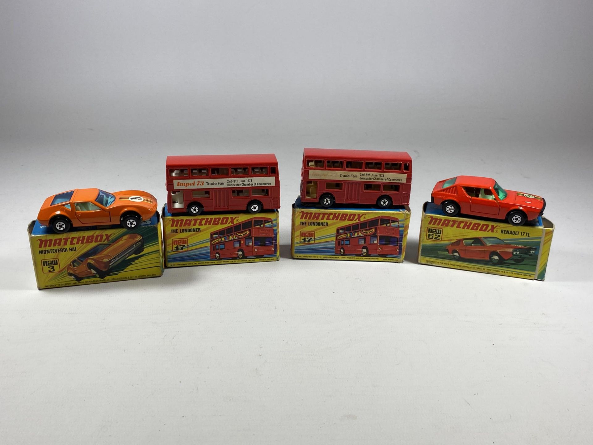 A GROUP OF FOUR VINTAGE MATCHBOX NEW DIECAST MODELS TO INCLUDE TWO X THE LONDONER BUSES