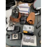AN ASSORTMENT OF CAMERA EQUIPMENT TO INCLUDE A KODAK BROWNIE AND TWO CANON CAMERAS