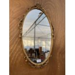 A VINTAGE DECORATIVE BRASS FRAMED WALL MIRROR