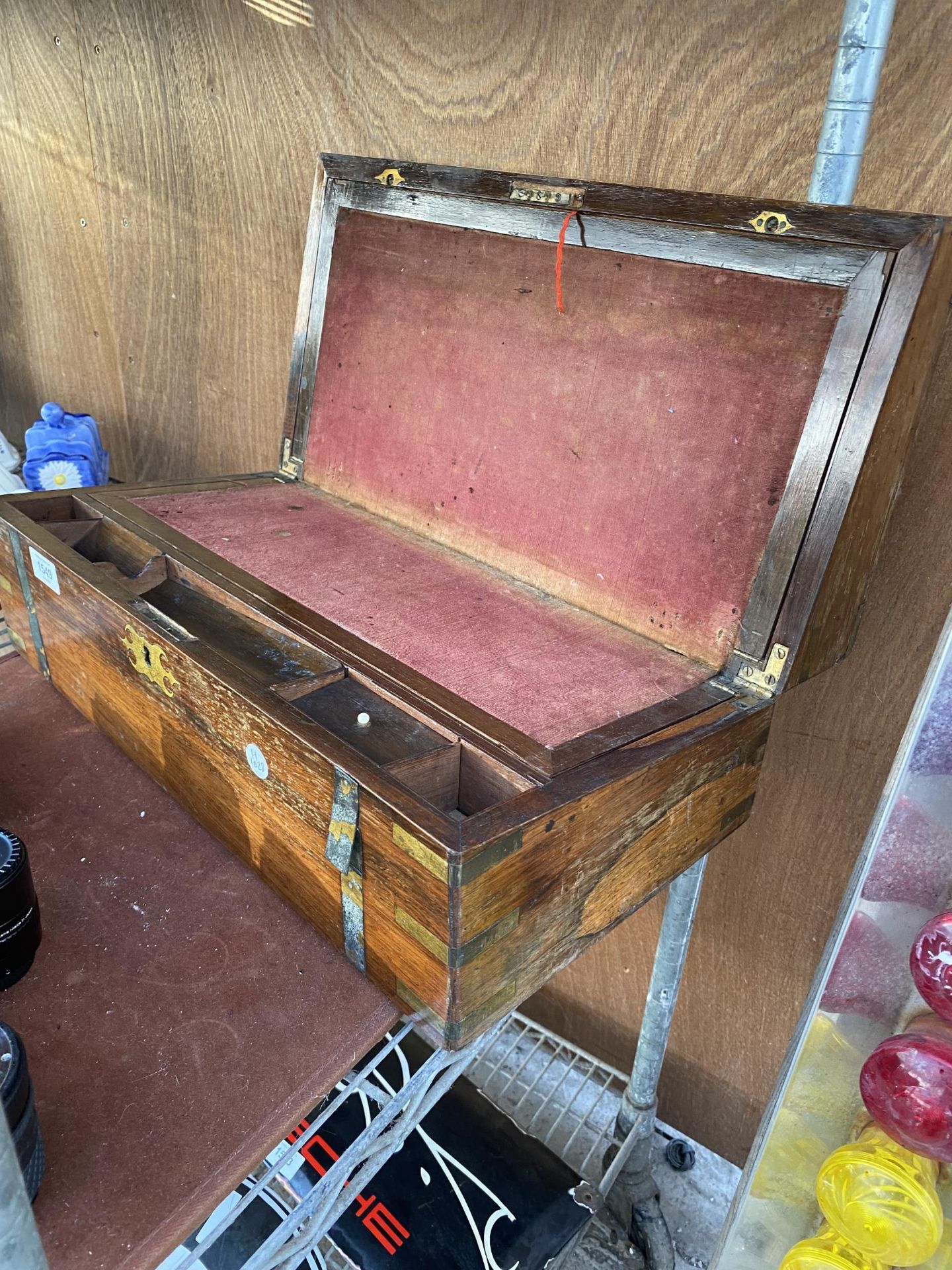 A VINTAGE MAHOGANY WRITING SLOPE WITH RED CLOTH INTERIOR