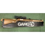 A GAMO HUNTER 440 .22 AIR RIFLE WITH SCOPE AND PELLET TINS