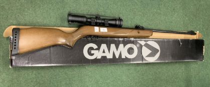 A GAMO HUNTER 440 .22 AIR RIFLE WITH SCOPE AND PELLET TINS