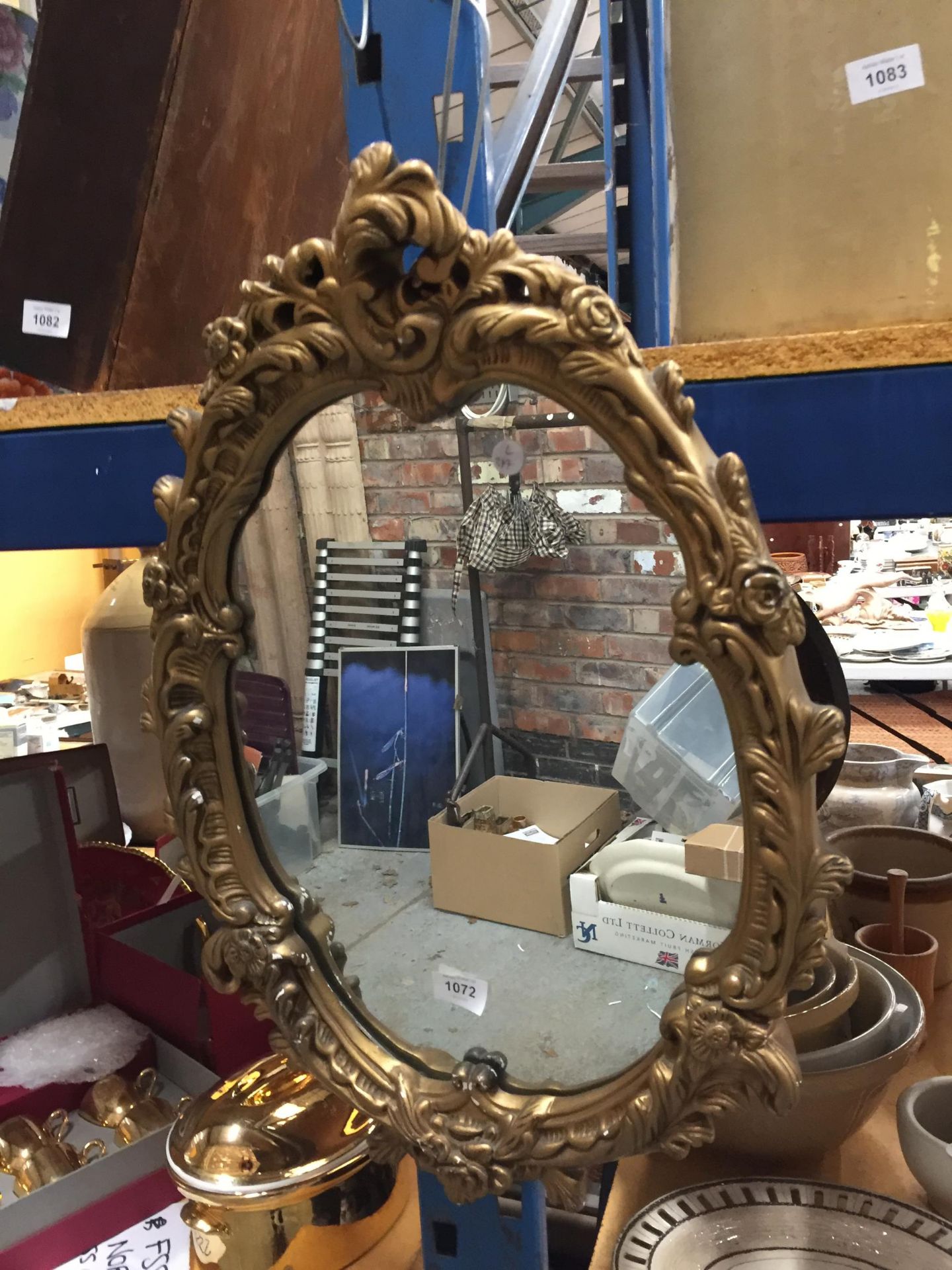 A VINTAGE STYLE OVAL MIRROR WITH ORNATE GILT FRAME