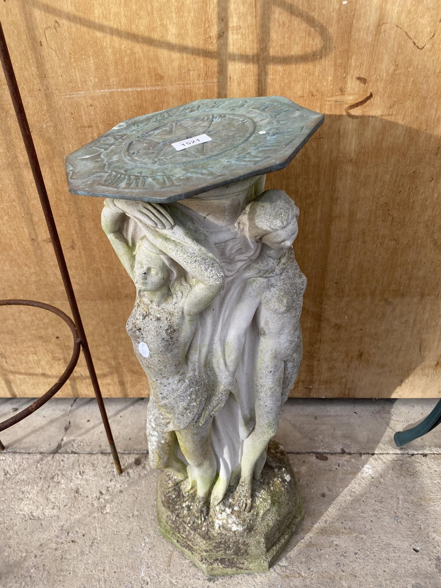 A RECONSTITUTED STONE CHERUB SUNDIAL WITH BRASS TOP (MISSING THE POINT)