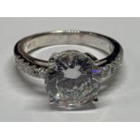 A SILVER RING WITH CUBIC ZIRCONIAS IN A PRESENTATION BOX