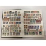 A STAMP ALBUM FROM THE 1900'S WITH VARIOUS COUNTRIES STAMPS