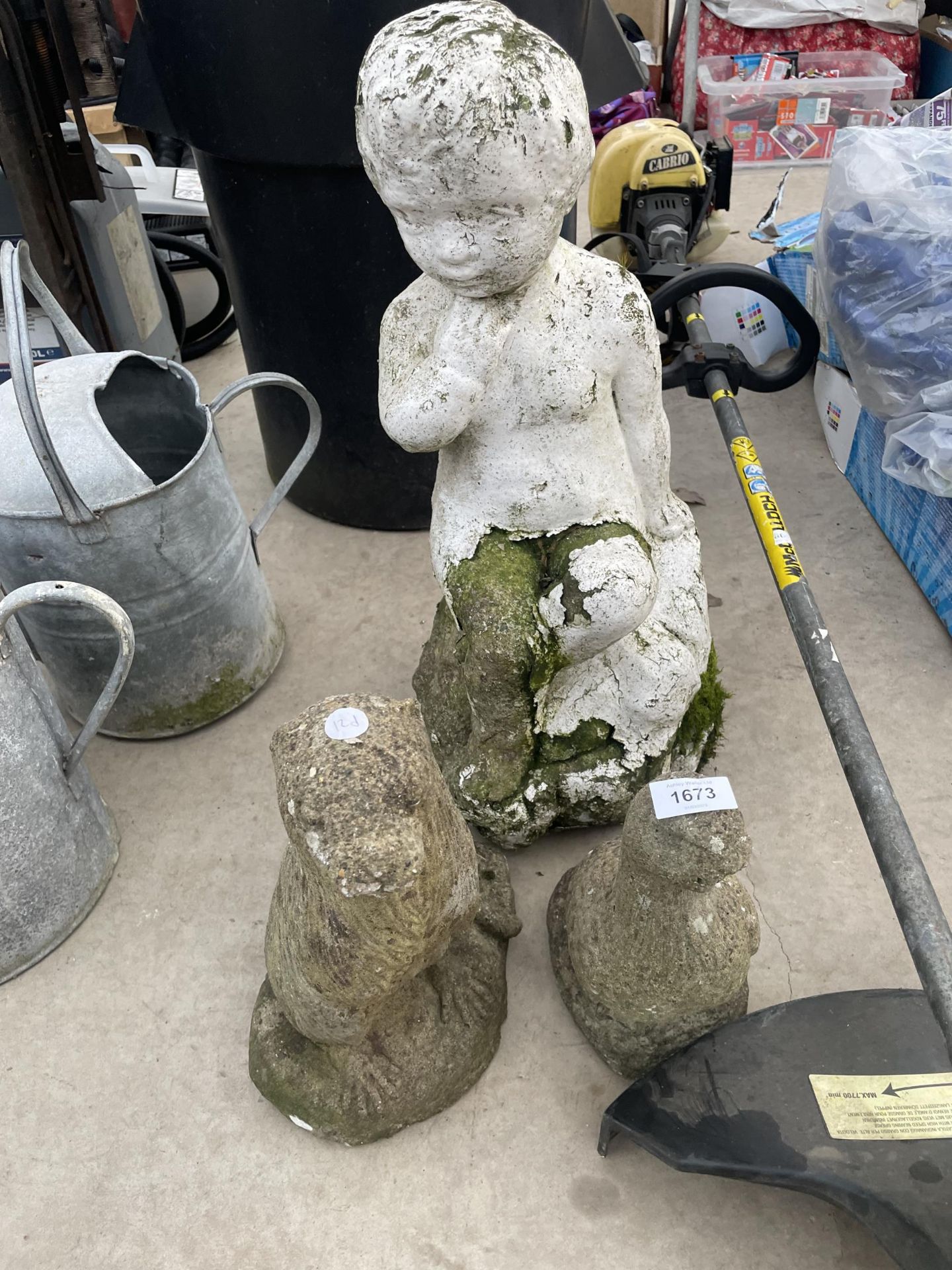 THREE RECONSTITUTED STONE GARDEN FIGURES TO INCLUDE AN OTTER AND A CHERUB ETC